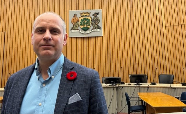 Coun. Stephen Holyday, who chairs Etobicooke's community council, says he wants a halt to the city's plan to scrap the Etobicoke coat of arms until councillors have an opportunity to debate the issue. (Mike Smee/CBC - image credit)