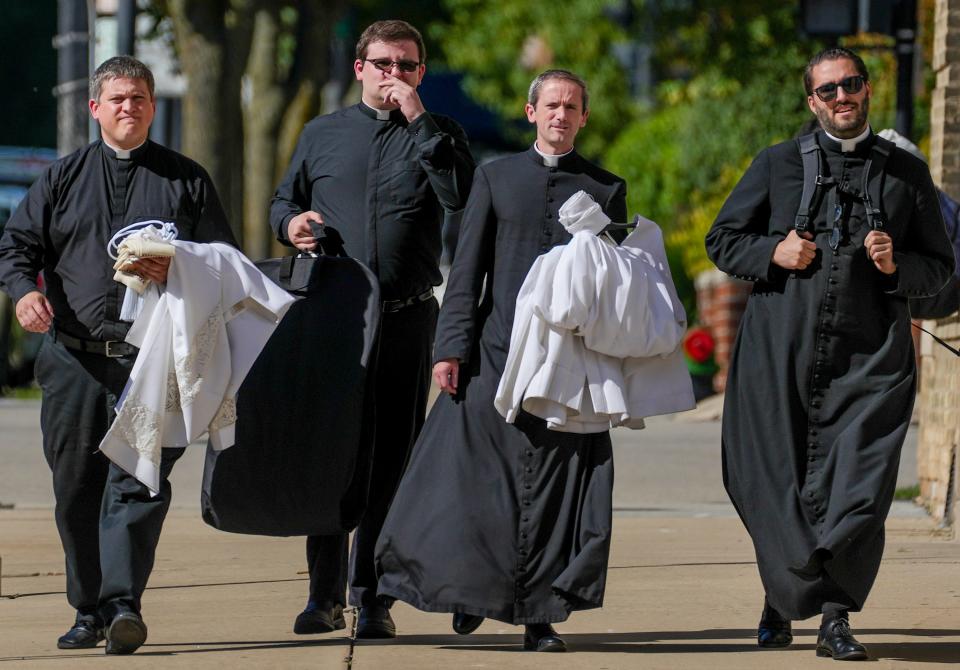Four priests make their way into the public funeral for former Archbishop Rembert Weakland on Tuesday at the Cathedral of St. John the Evangelist in downtown Milwaukee.