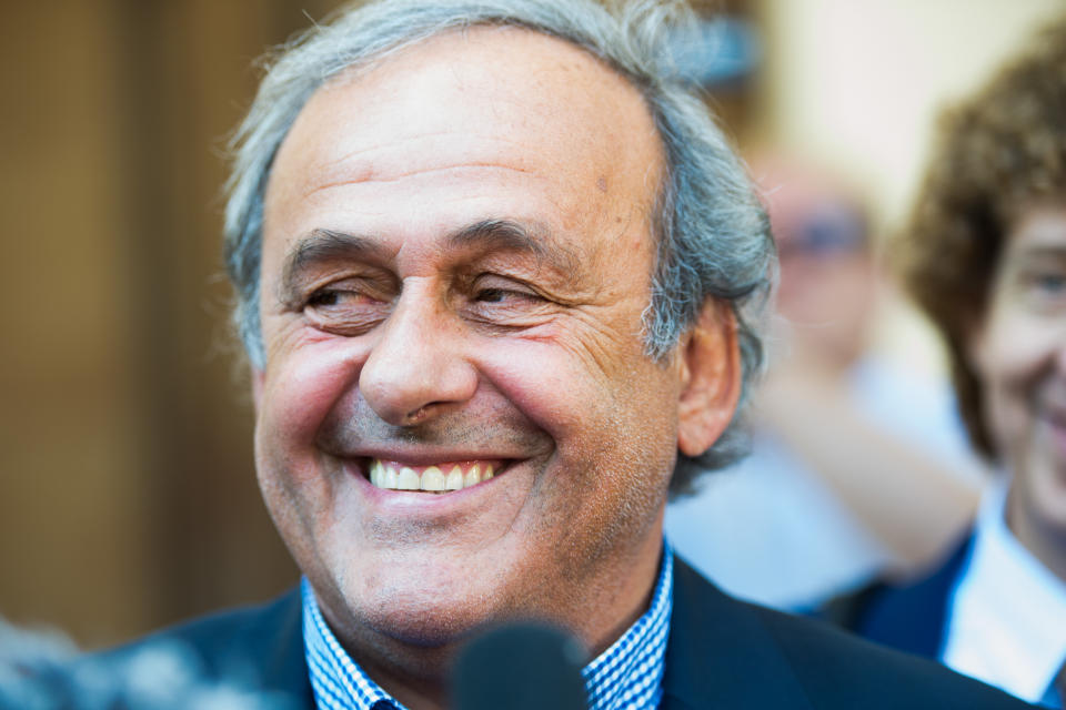 The former president of the the European Football Association (Uefa), Michel Platini, center, surrounded by media representatives, speaks to the press in front of the Swiss Federal Criminal Court in Bellinzona, Switzerland, at the last day of the trail, after the verdict has been announced, Friday, July 8, 2022. The trial ended with an acquittal. Former Fifa President Joseph Blatter and Platini, stood trial before the Federal Criminal Court over a suspicious two-million payment. The Federal Prosecutor's Office accused them of fraud. The defense spoke of a conspiracy. (Ti-Press/Alessandro Crinari/Keystone via AP)