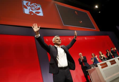 Britain's Labour Party leader Jeremy Corbyn watches Mayor of London Sadiq Khan take the applause during the third day of the Labour Party conference in Liverpool, Britain, September 27, 2016. REUTERS/Darren Staples