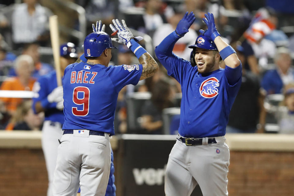 Chicago Cubs' Victor Caratini, right, celebrates with teammate Javier Baez (9) after Baez and Kris Bryant also scored on his seventh-inning three-run home run during a baseball game against the New York Mets, Thursday, Aug. 29, 2019, in New York. (AP Photo/Kathy Willens)