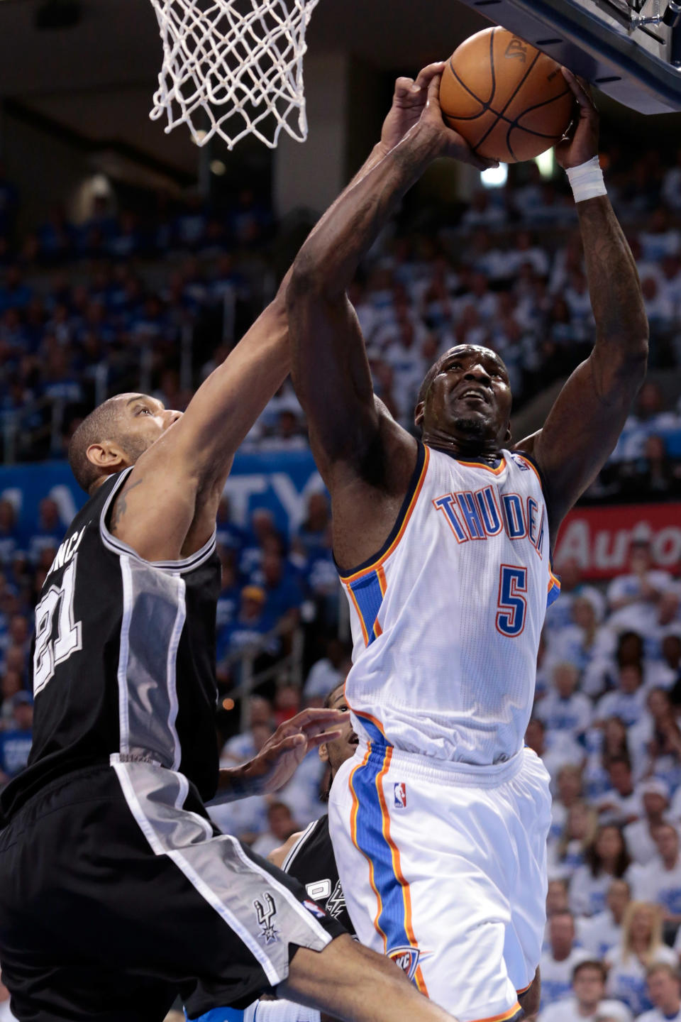 OKLAHOMA CITY, OK - JUNE 02: Kendrick Perkins #5 of the Oklahoma City Thunder goes up for a shot against Tim Duncan #21 of the San Antonio Spurs in the first quarter in Game Four of the Western Conference Finals of the 2012 NBA Playoffs at Chesapeake Energy Arena on June 2, 2012 in Oklahoma City, Oklahoma. NOTE TO USER: User expressly acknowledges and agrees that, by downloading and or using this photograph, User is consenting to the terms and conditions of the Getty Images License Agreement. (Photo by Brett Deering/Getty Images)