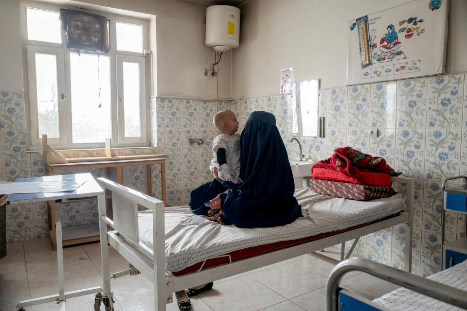 Fatima, an Afghan mother who goes by only one name, caring for her 10-month-old daughter Salma in Maidan Shahr Hospital’s acute-malnutrition ward. (Yuka Tachibana / NBC News)