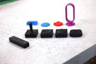 <p>The Microsoft Adaptive Mouse kit with the Mouse, Hub and three different Buttons with different toppers on them. In the background are four 3D printed toppers in colors like blue, red and purple.</p> 