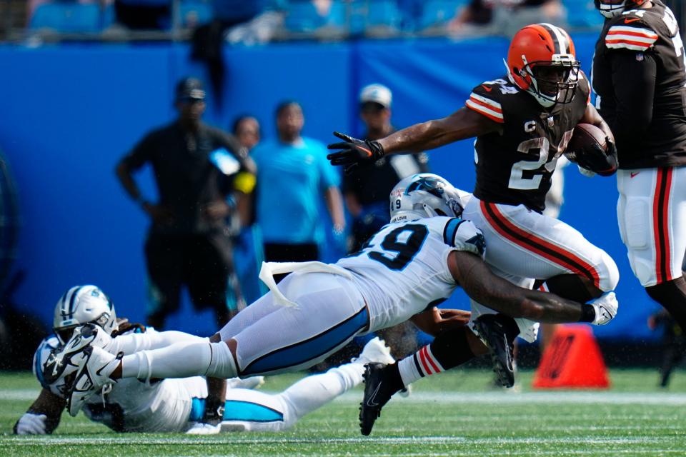 Cleveland Browns running back Nick Chubb is tackled by Carolina Panthers linebacker Frankie Luvu during the second half of an NFL football game on Sunday, Sept. 11, 2022, in Charlotte, N.C. (AP Photo/Rusty Jones)