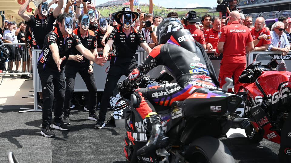 Maverick Viñales' team greets him at the finish wearing Caped Crusader masks. - Jonathan Hawkins/CNN