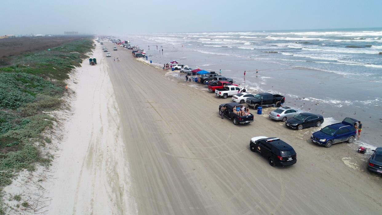 Cars line the beach in Port Aransas during Spring Break 2019 on Wednesday, March, 13, 2019.