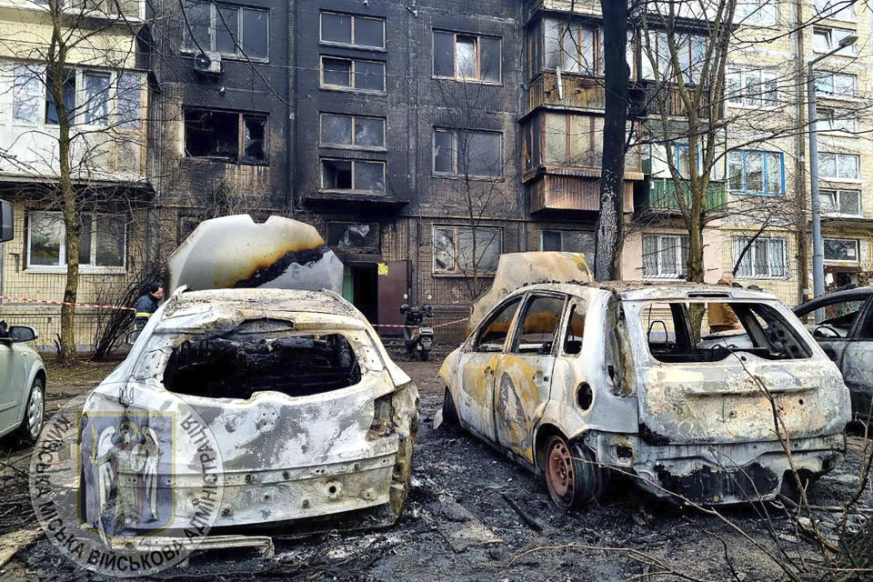 In this photo provided by Serhii Popko, the head of the city's military administration, burned car are seen at the site after Russian attacks in Kyiv, Ukraine, Thursday, March 21, 2024. Around 30 cruise and ballistic missiles were shot down over Kyiv on Thursday morning, according Serhii Popko. The missiles were entering Kyiv simultaneously from various directions in a first missile attack on the capital in 44 days. (Serhii Popko, the head of the city's military administration via AP)