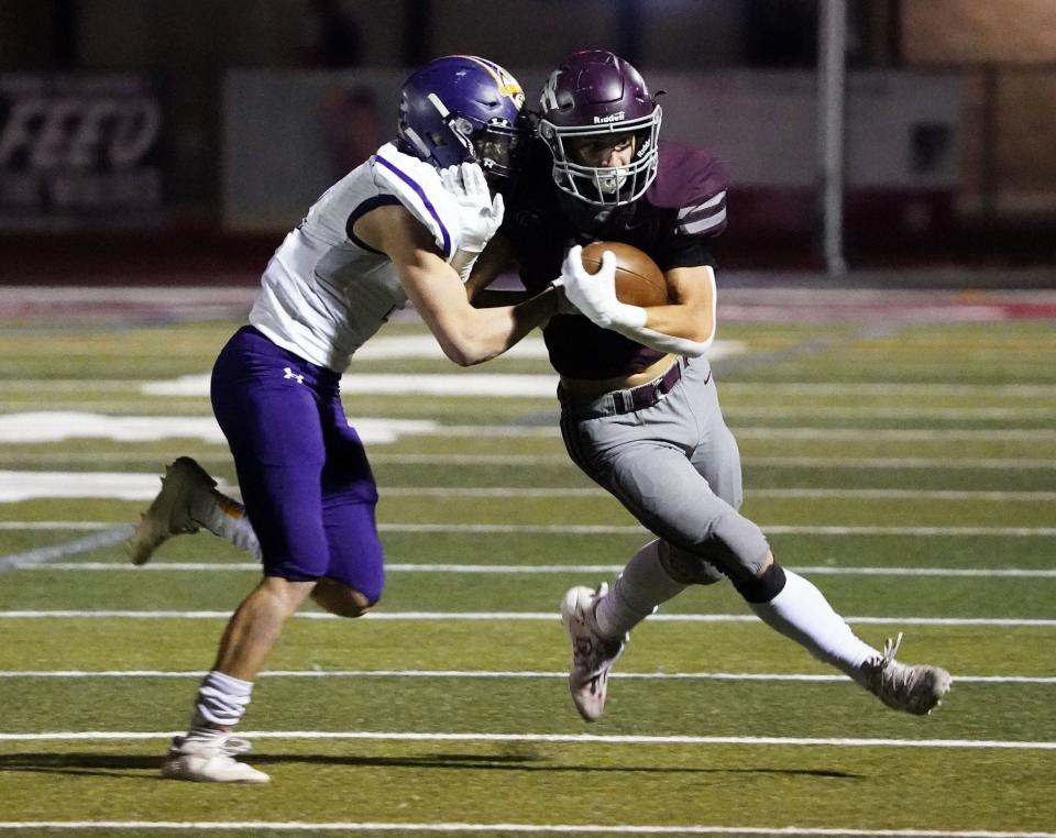 Nov 26, 2021; Scottsdale, Arizona, USA; Sunrise Mountain Mustangs safety Gage Buckhannon (2) drives Desert Mountain Wolves running back Zack Kilburg (2) to the sidelines during the 5A quarterfinals at Desert Mountain High School. Mandatory Credit: Rob Schumacher-Arizona Republic