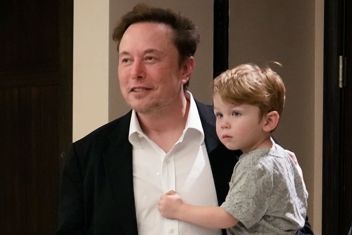 Elon Musk pictured with his son X in Miami  (AP)