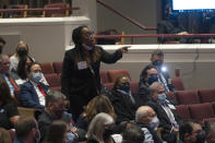 Virginia Liberation Party gubernatorial candidate Princess Blanding interrupts the debate between Democrat Terry McAuliffe and Republican Glenn Youngkin, at Northern Virginia Community College, in Alexandria, Va., Tuesday, Sept. 28, 2021. Blanding was demanding that she be allowed a place onstage during the debate. (AP Photo/Cliff Owen)