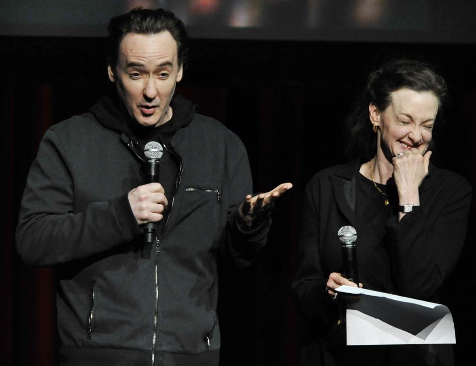 Actors John Cusack left, and Joan Cusack right, talk about Roger Ebert during a memorial for the film critic at The Chicago Theater in Chicago, Thursday, April 11, 2013. The Pulitzer Prize winning critic died last week at the age of 70 after a long battle with cancer. (AP Photo/Paul Beaty)