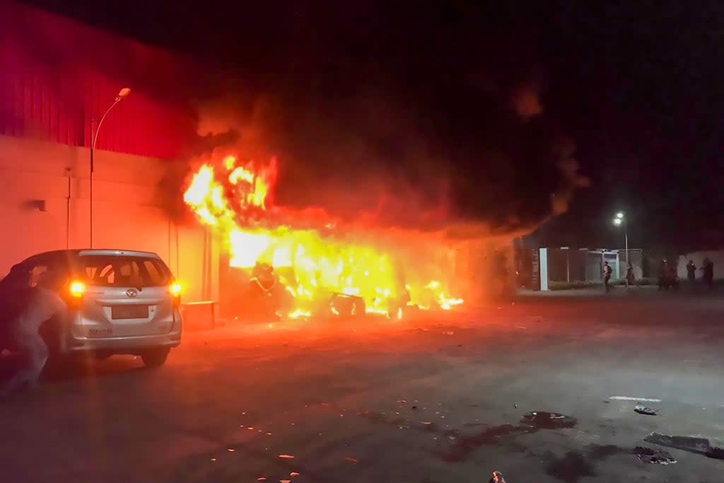 A fire burns at the Double O nightclub where at least 18 people were killed in clashes between two groups in Sorong in Indonesia’s West Papua province on 25 January 2022 (AFP via Getty Images)