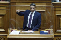 Greece's Prime Minister Kyriakos Mitsotakis speaks during a parliament debate in Athens, Wednesday, Aug. 26, 2020. Mitsotakis says his country is planning to exercise its legal right to extend territorial waters along its western coastline from six to 12 nautical miles. The plan was announced Wednesday as Greece remains locked in an escalating dispute over maritime boundaries with neighbor Turkey, with a survey mission and military exercises currently being held in east Mediterranean waters claimed by both countries. (AP Photo/Thanassis Stavrakis)