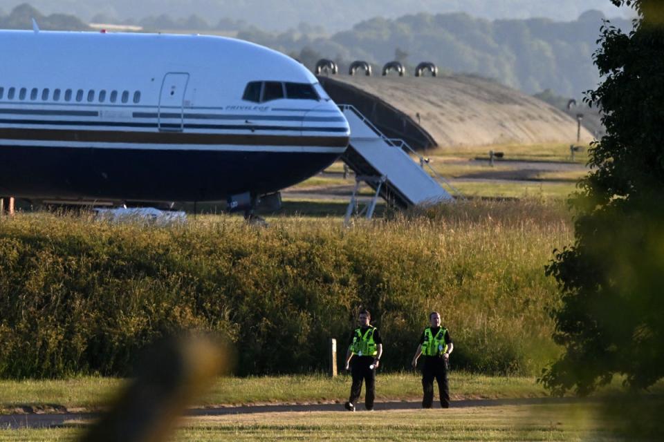 A Boeing 767 sits on the runway at the military base in Amesbury, Salisbury, on 14 June, preparing to take a number of asylum seekers to Rwanda (AFP via Getty Images)
