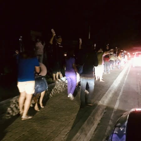 People are seen receiving medical assistance outside Kidapawan Doctors Hospital in Kidapawan City, after an earthquake, in Kidapawan City