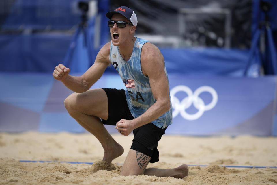 FILE - Tri Bourne, of the United States, celebrates after the team's win in a men's beach volleyball match against Switzerland at the 2020 Summer Olympics, July 28, 2021, in Tokyo. The AVP is heading back to the beach with a bunch of new teams and a lot more tournaments for them to figure things out. Bourne is back with his old teammate, Trevor Crabb. (AP Photo/Felipe Dana, File)