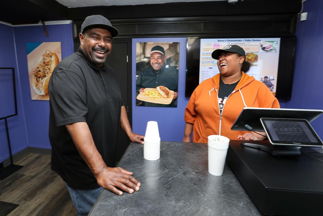 Barry Washington, left, owner of a new Barry Cheesesteaks in Valley Station, shares a laugh with cashier Clara Butler at the restaurant in Louisville, Ky. on Jan. 10, 2023.  