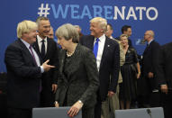 FILE - In this Thursday, May 25, 2017 file photo U.S. President Donald Trump jokes with British Foreign Minister Boris Johnson as British Prime Minister Theresa May walks past during a working dinner meeting at the NATO headquarters during a NATO summit of heads of state and government in Brussels. (AP Photo/Matt Dunham, Pool, File)