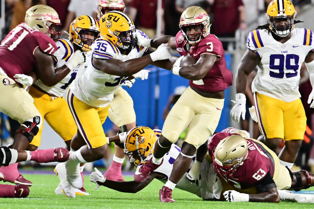  Trey Benson #3 of the Florida State Seminoles breaks a tackle from Sai'vion Jones #35 of the LSU Tigers in the first quarter at Camping World Stadium on September 03, 2023 in Orlando, Florida.  