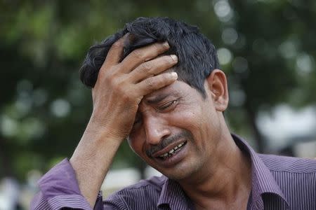 A man mourns for his relative, a garment worker who had died in the collapse of the Rana Plaza building, in Savar, around 30 km (19 miles) outside Dhaka April 30, 2013. REUTERS/Andrew Biraj