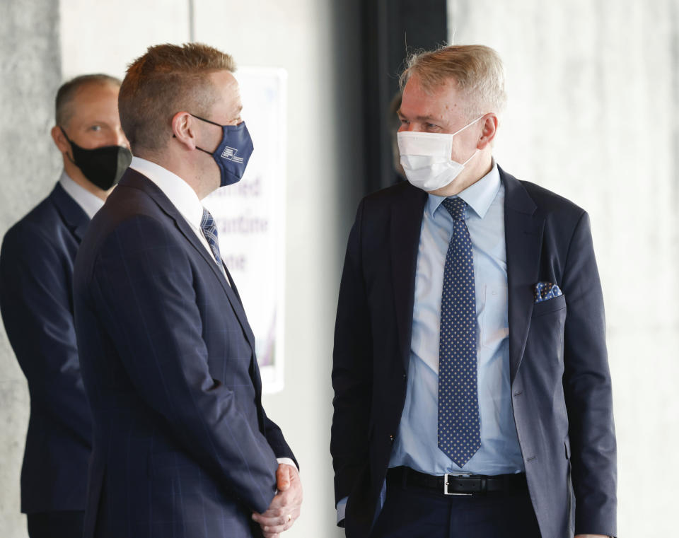 Finnish Foreign Minister Pekka Haavisto, right, is greeted by Icelandic Minister of Foreign Affairs Gudlaugur Thor Thordarson as he arrives for the Arctic Council Ministerial Meeting in Reykjavik, Iceland, Thursday, May 20, 2021. (AP Photo/Brynjar Gunnarsson, Pool)