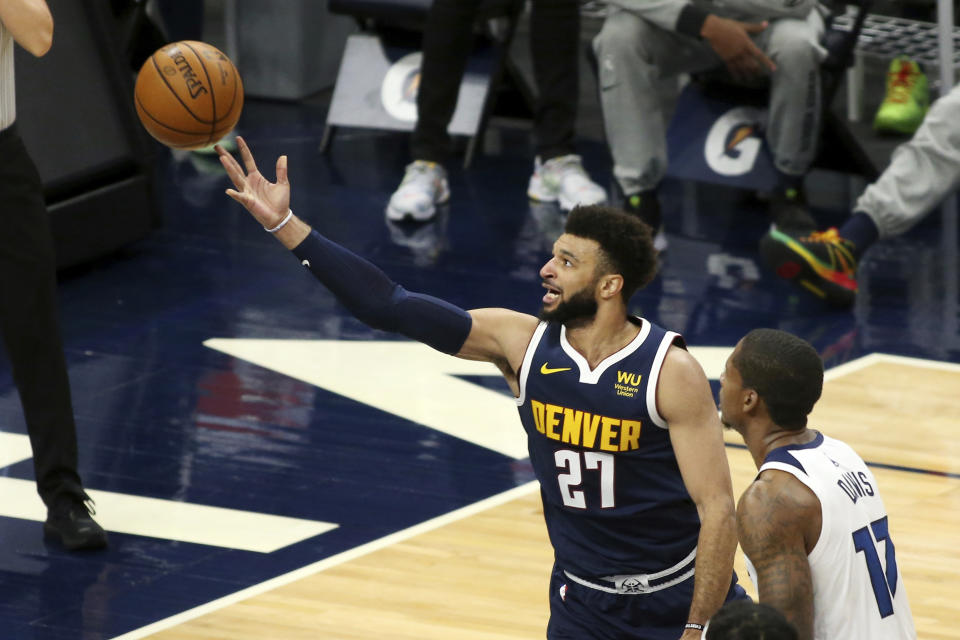 Denver Nuggets guard Jamal Murray shoots and is fouled on the play with Minnesota Timberwolves center Ed Davis (17) on defense in the first quarter during an NBA basketball game, Sunday, Jan. 3, 2021, in Minneapolis. (AP Photo/Andy Clayton-King)