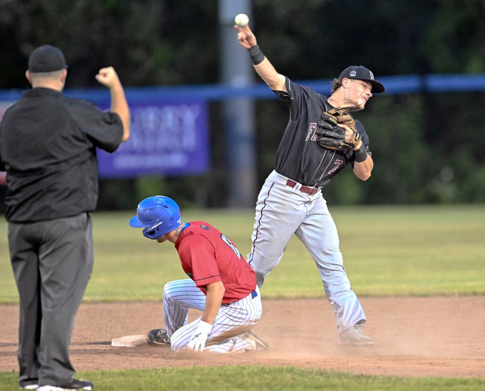 Falmouth second baseman Travis Bazzana turns a double play after forcing Nick Mitchell of Hyannis at second. Cape Cod Baseball League.