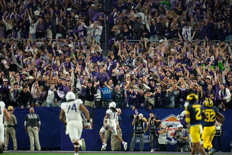 Fans cheer as TCU wide receiver Quentin Johnston (1) runs in for a 76-yard touchdown during the fourth quarter of a 51-45 win over Michigan in the Fiesta Bowl on Saturday in Glendale, Ariz.