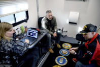Counselors Katie Tousley, left, Austin Wilmarth, center; and John Shamy, right, sit inside a mobile outreach center near Club Q on Wednesday, Nov. 23, 2022. The center, which is run by the U.S. Department of Veterans Affairs, offered services to veterans, service members and the community following a shooting at the gay night club that killed five people Saturday night. (AP Photo/Thomas Peipert)