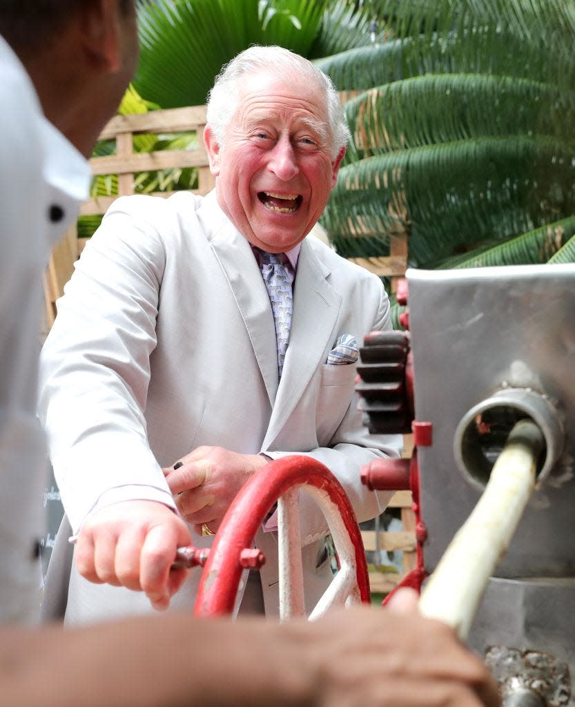 King Charles laughs as he grinds sugar cane in Cuba