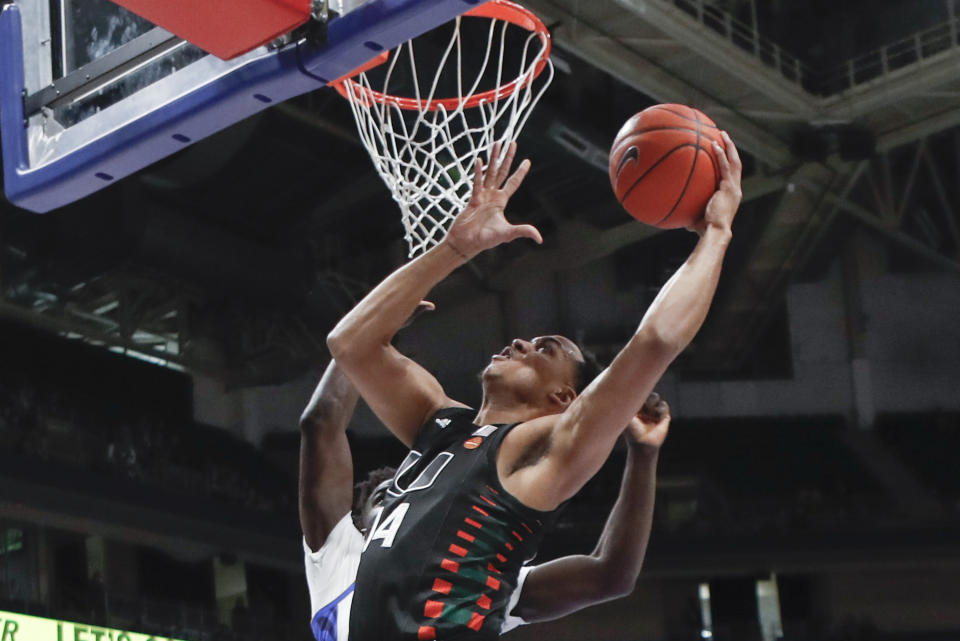 Miami's Rodney Miller Jr. (14) shoots in front of Pittsburgh's Eric Hamilton during the first half of an NCAA college basketball game, Sunday, Feb. 2, 2020, in Pittsburgh. (AP Photo/Keith Srakocic)