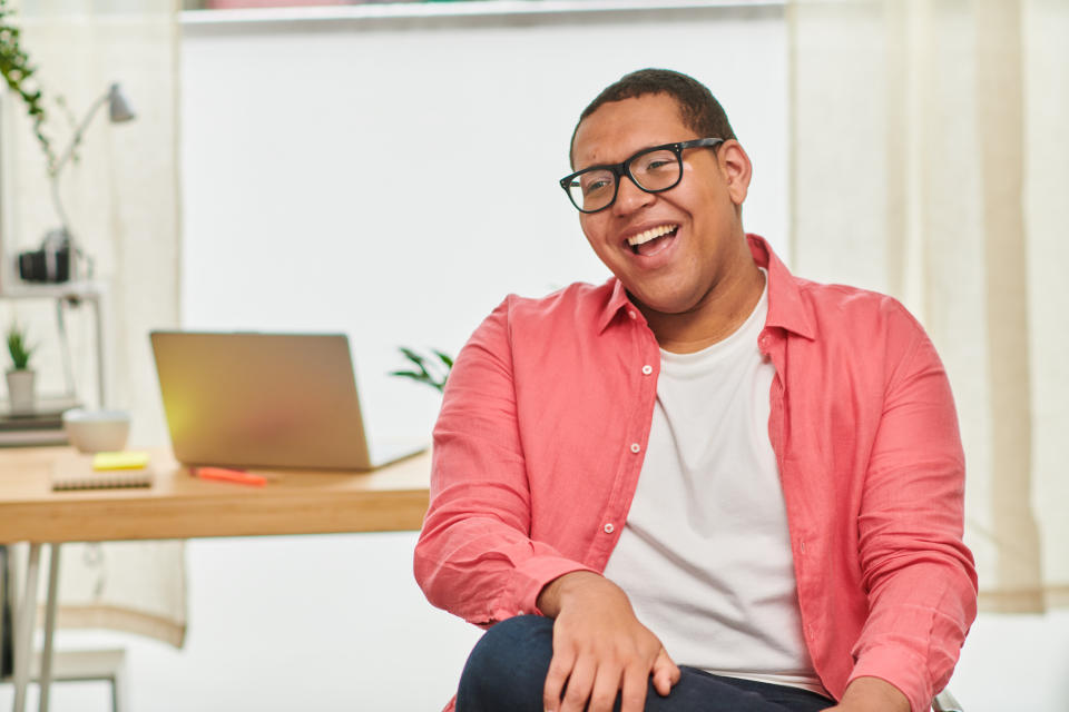 Almost 70 per cent of those surveyed who have a formal autism diagnosis said it had a positive impact on their personal identity. (Getty) Close up portrait of happy, confident young man with autism and vitiligo in office laughing