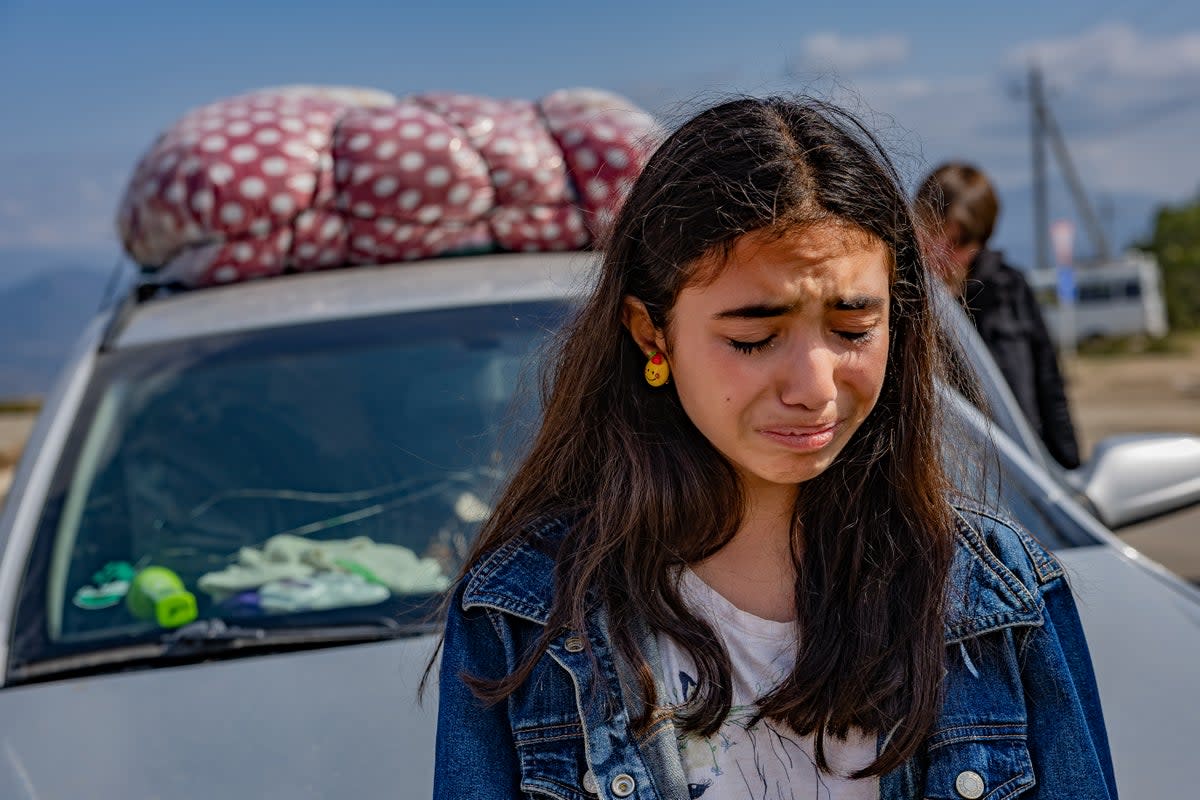 A teenager from Nagorno-Karabakh cries as she crosses the border to Armenia (Bel Trew)