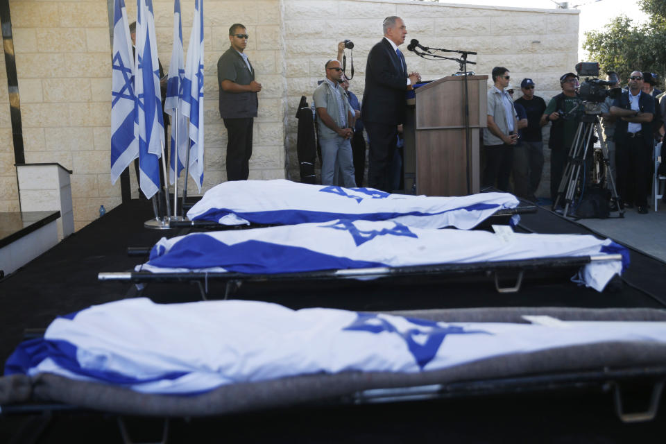 FILE - In this July 1, 2014 file photo, Israeli Prime Minister Benjamin Netanyahu eulogizes three Israeli teens who were abducted and killed in the West Bank during their joint funeral in the Israeli city of Modiin. HBO's new docudrama series about the killings of four Israeli and Palestinian teenagers, which set off a cascade of events leading to the 2014 Gaza war, is set to air next week and is likely to reopen wounds on both sides of the conflict. “Our Boys,” co-created by Palestinian and Israeli filmmakers, presents a dramatized rendition of the chaotic events of that June following the abduction of three Israeli teens in the West Bank. (AP Photo/Baz Ratner, Pool, File)
