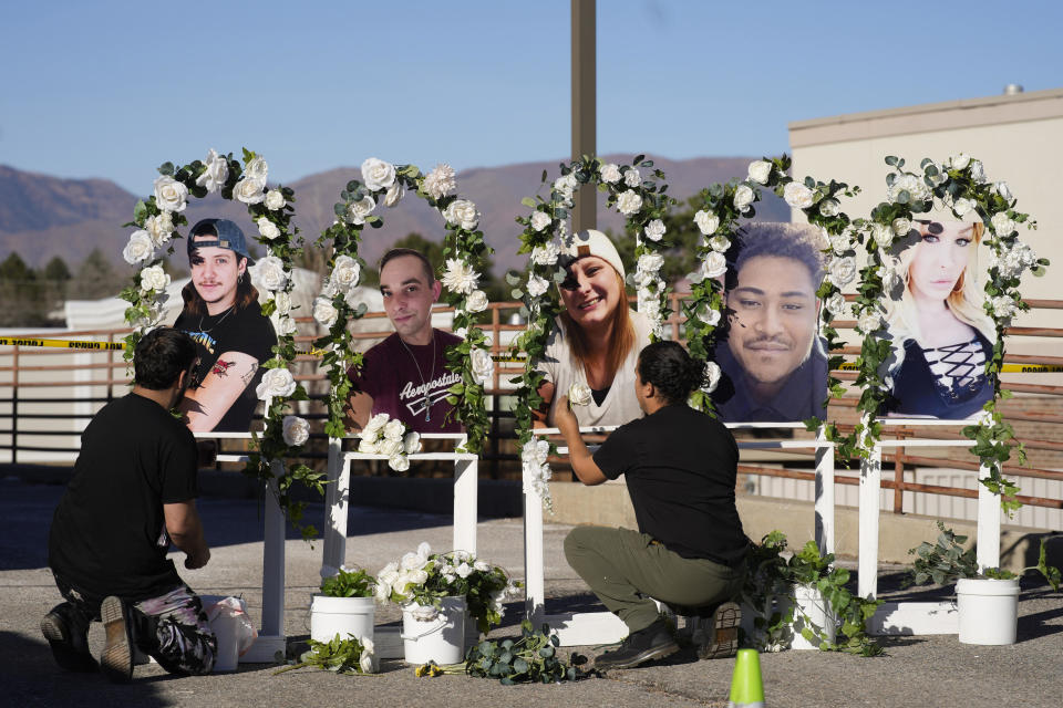 Noah Reich, left, and David Maldonado, the Los Angeles co-founders of Classroom of Compassion, put up a memorial with photographs of the five victims of a weekend mass shooting at a nearby gay nightclub on Tuesday, Nov. 22, 2022, in Colorado Springs, Colo.  / Credit: David Zalubowski / AP