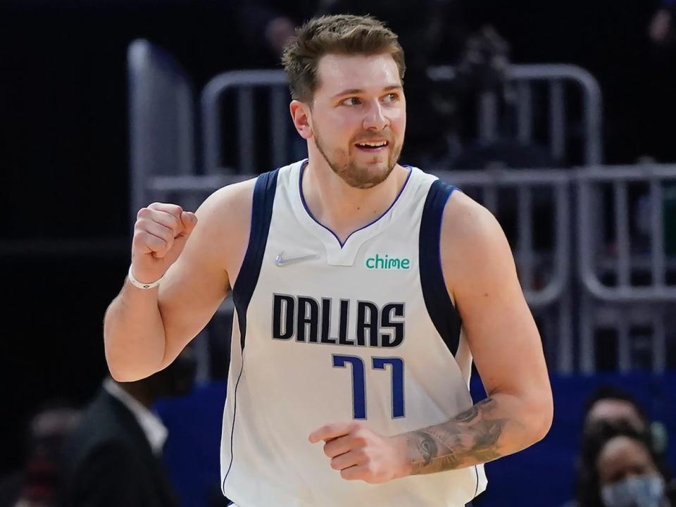 Luka Doncic pumps his fist and smiles during a game in 2022.
