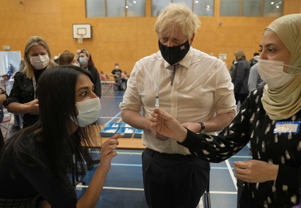 Boris Johnson watches as a dose of the Pfizer vaccine is diluted before being administered (Matt Dunham/PA) (PA Wire)