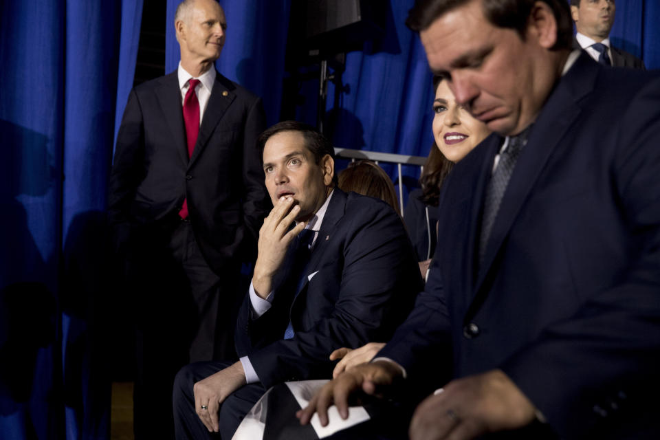 From left, Sen. Rick Scott, R-Fla., Sen. Marco Rubio, R-Fla., and Florida Gov. Ron DeSantis arrive before President Donald Trump speaks to a Venezuelan American community at Florida Ocean Bank Convocation Center at Florida International University in Miami, Fla., Monday, Feb. 18, 2019, to speak out against President Nicolas Maduro's government and its socialist policies. (AP Photo/Andrew Harnik)