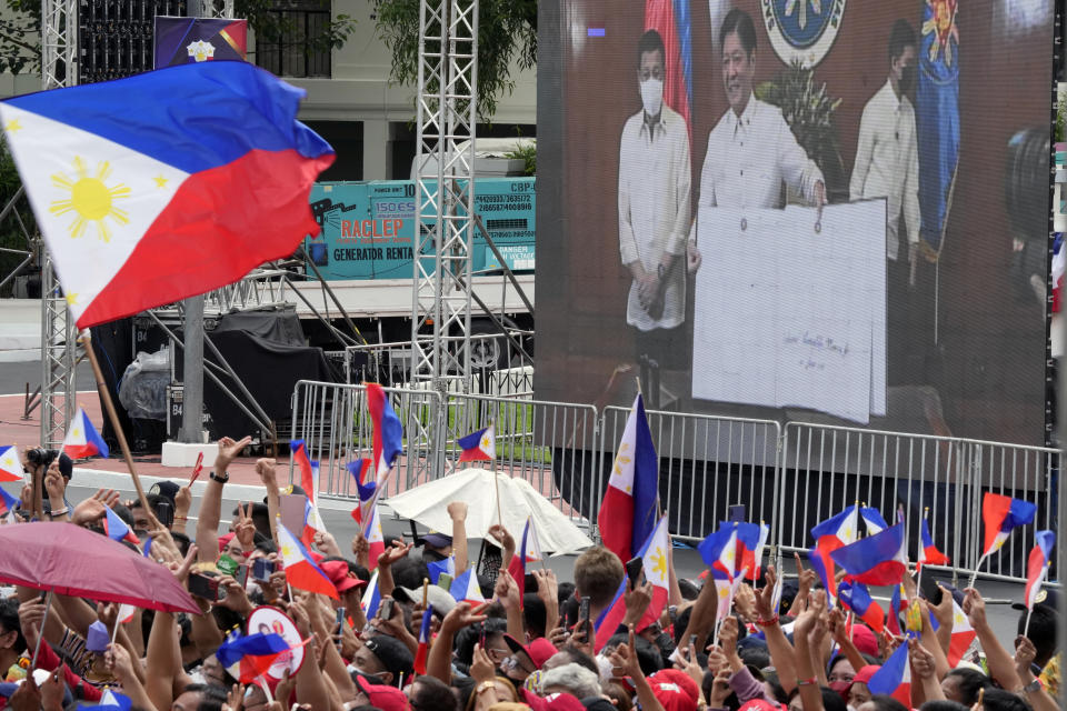 A screen show incoming Philippine president Ferdinand Marcos Jr. and outgoing President Rodrigo Duterte at the inauguration ceremony venue at National Museum on Thursday, June 30, 2022 in Manila, Philippines. Marcos was sworn in as the country's 17th president. (AP Photo/Aaron Favila)