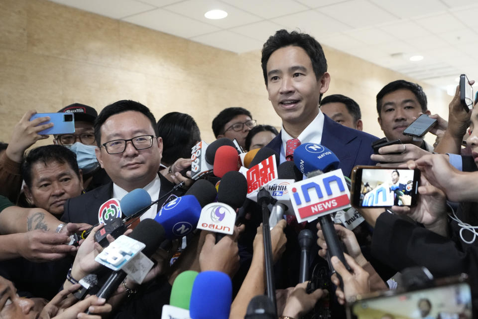 Former leader of the Move Forward Party Pita Limjaroenrat, right, with the current leader of the party Chaithawat Tulathon, left, talks to reporters before listening to the live verdict at parliament in Bangkok, Thailand, Wednesday, Jan. 31, 2024. Thailand's Constitutional Court delivers its verdict on an accusation that the progressive party Move Forward's election pledge to amend the lese majeste law was equivalent to an attempt to overthrow the constitutional monarchy system. If the charge is upheld, the party, which won the 2023 election, could face dissolution. (AP Photo/Sakchai Lalit)