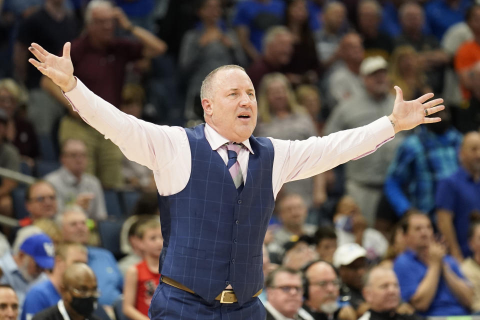 FILE - Texas A&M head coach Buzz Williams waves at his players during overtime of an NCAA men's college basketball game at the Southeastern Conference tournament in Tampa, Fla., Thursday, March 10, 2022. Texas A&M coach Buzz Williams criticized the selection committee last season after his team got left out of the field. The Aggies won’t have to sweat out Selection Sunday if they can build on the momentum they established late last season, when they won 11 of their final 13 games. (AP Photo/Chris O'Meara, File)