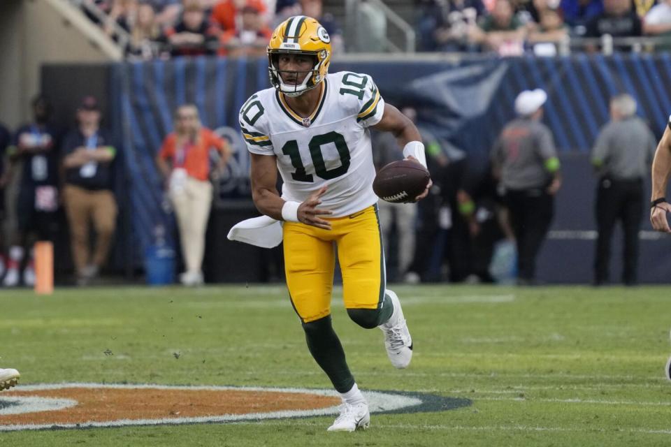 Green Bay Packers quarterback Jordan Love (10) runs in the open field.