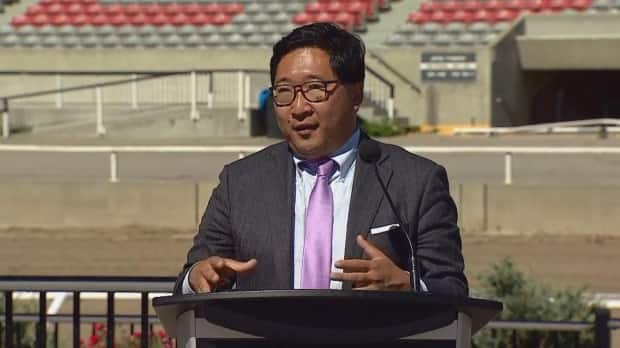 Dr. Jia Hu, public health physician adviser to the Calgary Stampede, says multiple modifications are being made to the usual operation of the annual event in response to the COVID-19 pandemic.  (CBC - image credit)