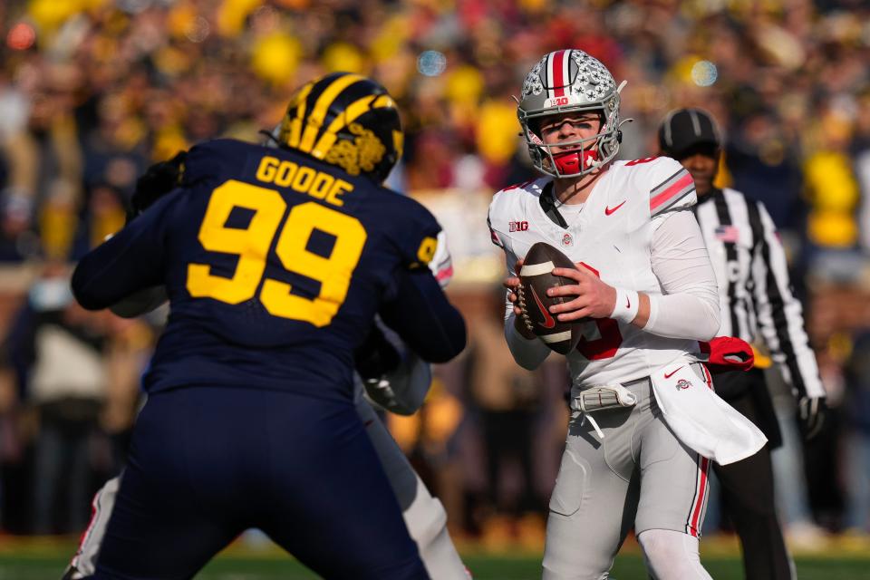 Nov 25, 2023; Ann Arbor, Michigan, USA; Ohio State Buckeyes quarterback Kyle McCord (6) looks to pass over Michigan Wolverines defensive lineman Cam Goode (99) during the NCAA football game at Michigan Stadium. Ohio State lost 30-24.