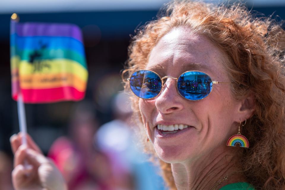 A member of the Jewish Federation of Palm Beach County group waves a Pride flag during the 2023 Palm Beach Pride Parade in downtown Lake Worth Beach.
