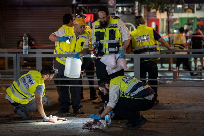 Israeli forensic officers work at the scene of a shooting in the mixed Arab-Jewish neighborhood of Jaffa. Six people were killed in a shooting on Jerusalem Boulevard, according to Israeli police. Ilia Yefimovich/dpa