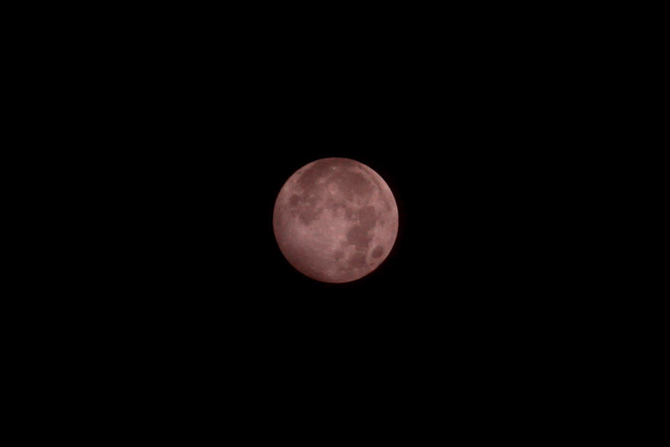 The Strawberry Moon is seen during the Penumbral Lunar Eclipse over the sky of Bekasi city, West Java province on June 6, 2020.  / Credit: Aditya Irawan/NurPhoto via Getty Images