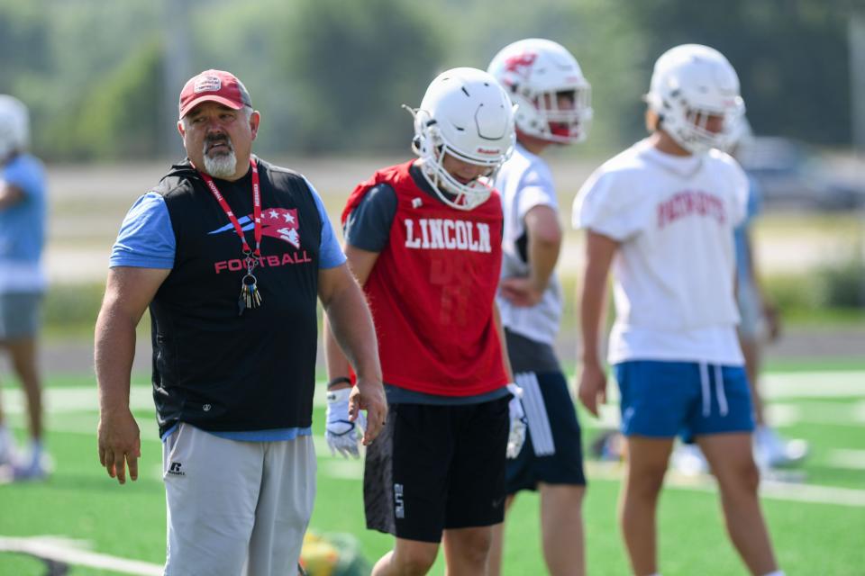 Coach Jared Fredenburg running players through practice drills at Lincoln High School in Sioux Falls, South Dakota on Monday, August 7, 2023.