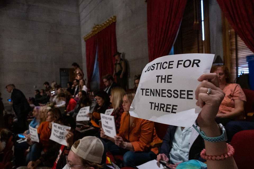 Protesters in the gallery of the Tennessee state Capitol hold signs that read: Justice for the Tennessee Three.